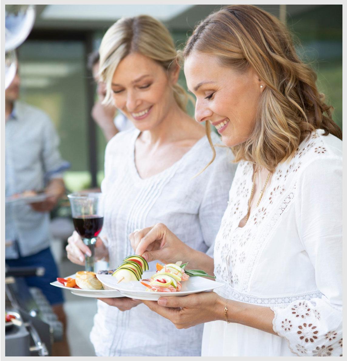 Two female friends choose tasty skewers.