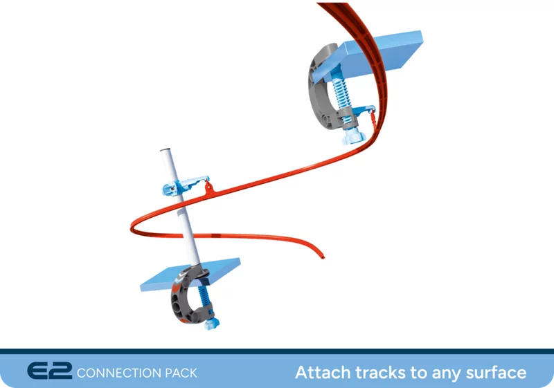 Clamp elements on a white background. Close-up of SKY TRAILS clamp connectors on a red track - versatile components for creative track layouts; ideal for kids ages 7 and up.