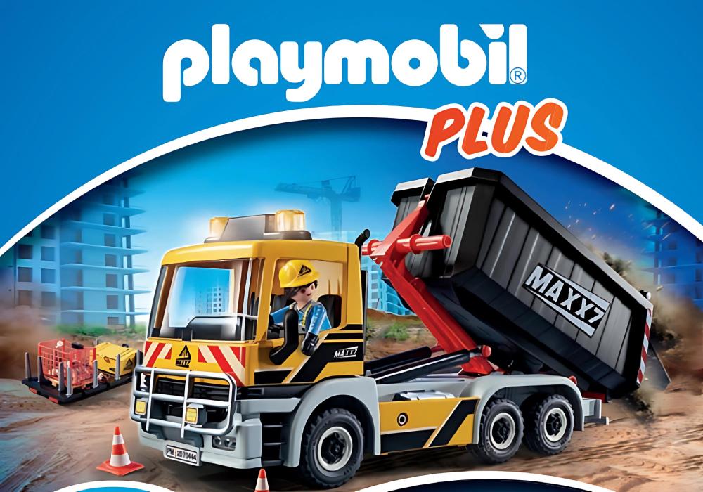 "PLAYMOBIL PLUS promotional banner showcasing a construction theme with a detailed toy dump truck in action on a construction site, under the logo 'PLAYMOBIL PLUS'. The scene includes a construction worker figure and other vehicles in the background."