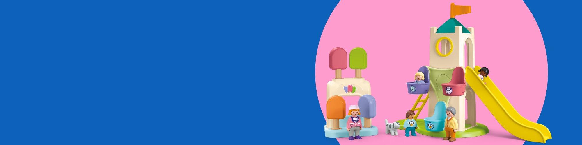 Playmobil toddler playground toy set with tower slide, ice cream kiosk, and preschool figures on colorful pink and blue backdrop